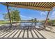 Scenic view from a shaded area with tables, overlooking a serene lake and green landscape at 2846 Central Park Blvd, Denver, CO 80238