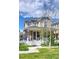 Charming two-story home featuring a classic white picket fence and lovely front yard landscaping at 2846 Central Park Blvd, Denver, CO 80238