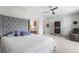 Serene main bedroom features a tufted headboard, ceiling fan, and ample closet space at 2846 Central Park Blvd, Denver, CO 80238