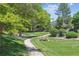 Beautifully landscaped community park with walking path, mature trees, and lush green grass at 4750 S Dudley St # 21, Littleton, CO 80123