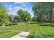 Expansive community greenspace with walking path, mature trees, and lush green grass at 4750 S Dudley St # 21, Littleton, CO 80123