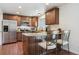 Well-equipped kitchen with stainless steel appliances, granite countertops, wood cabinets, and an island with seating at 4750 S Dudley St # 21, Littleton, CO 80123