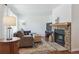 Cozy living room with a stone fireplace, plush sofa, decorative rug, and a view of the backyard at 4750 S Dudley St # 21, Littleton, CO 80123