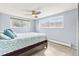 Serene bedroom featuring two large windows, a ceiling fan, and plush carpeting, creating a relaxing retreat at 75 N Emerson St # 206, Denver, CO 80218