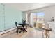 Bright dining area with a round table set and sliding glass doors to a balcony, offering a cozy spot to enjoy meals at 75 N Emerson St # 206, Denver, CO 80218