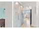 Clean hallway featuring a wall of sleek, frosted glass cabinets leading into an open kitchen with stainless appliances at 75 N Emerson St # 206, Denver, CO 80218