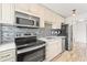 Modern kitchen with stainless steel appliances and sleek countertops, perfect for cooking and entertaining in style at 75 N Emerson St # 206, Denver, CO 80218