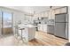 Well-lit kitchen with a breakfast bar, stainless steel appliances, and ample cabinet space, perfect for culinary adventures at 75 N Emerson St # 206, Denver, CO 80218