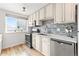 Updated kitchen featuring stainless steel appliances, ample cabinet space, and a bright window, offering a modern cooking experience at 75 N Emerson St # 206, Denver, CO 80218