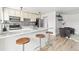 Modern kitchen features a marble breakfast bar with seating, sleek stainless steel appliances, and stylish lighting fixtures at 75 N Emerson St # 206, Denver, CO 80218