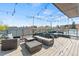 Spacious rooftop deck furnished with comfortable seating and charming string lights under a clear sky at 75 N Emerson St # 206, Denver, CO 80218