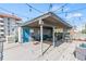 Open-air rooftop deck with a covered seating area, string lights, and stunning city views at 75 N Emerson St # 206, Denver, CO 80218