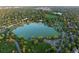 Scenic aerial view of a lake surrounded by lush greenery, with a park and cityscape in the distance at 1051 S York St, Denver, CO 80209