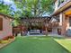 Inviting backyard featuring a pergola with outdoor seating, a manicured lawn, and a bar at 1051 S York St, Denver, CO 80209