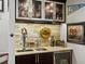 Cozy bar area featuring a stone backsplash, custom cabinetry, a beverage refrigerator, and elegant glassware at 1051 S York St, Denver, CO 80209