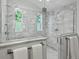 Modern bathroom featuring a spacious glass shower with dual showerheads and stylish marble tiling throughout at 1051 S York St, Denver, CO 80209