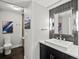 Contemporary bathroom featuring dark wood cabinets, a sleek vessel sink, modern lighting and a tiled shower at 1051 S York St, Denver, CO 80209