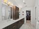 Elegant bathroom featuring double sinks, dark wood cabinetry, and a walk-in closet for ample storage at 1051 S York St, Denver, CO 80209