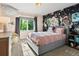 Cozy bedroom featuring stylish wallpaper, a comfortable bed, and plenty of natural light from the window at 1051 S York St, Denver, CO 80209