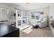 Bright bedroom featuring a unique bunk bed with house-like design and a comfortable gray armchair by the window at 1051 S York St, Denver, CO 80209