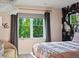 Bright bedroom with a large window, comfortable seating, and elegant floral wallpaper at 1051 S York St, Denver, CO 80209