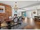 Elegant dining area featuring exposed brick, a stylish chandelier, and seamless flow to the living spaces at 1051 S York St, Denver, CO 80209