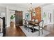 Stylish dining room features a wooden table with brick accent wall and a sliding barn door at 1051 S York St, Denver, CO 80209