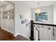 Bright hallway featuring framed photos on the wall, hardwood floors, a modern light fixture, and staircase at 1051 S York St, Denver, CO 80209