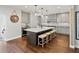 Spacious kitchen with island seating, modern pendant lights, and gray shaker cabinets at 1051 S York St, Denver, CO 80209