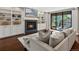 Bright living room with fireplace, built-in shelving, and sliding doors to the outdoor spa at 1051 S York St, Denver, CO 80209