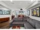 Basement living room featuring a comfortable gray sofa, sports memorabilia, and a cozy entertainment area at 1051 S York St, Denver, CO 80209