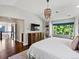 Serene main bedroom with a sitting area, built-in shelving, and large windows with picturesque views at 1051 S York St, Denver, CO 80209