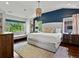 Bright and airy main bedroom featuring a large bed, sitting area, and beautiful natural light at 1051 S York St, Denver, CO 80209