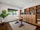 Bright home office with built-in shelving and a large window overlooking a well-maintained yard at 1051 S York St, Denver, CO 80209