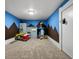 Spacious playroom with blue and brown accents, filled with various toys and playsets for creative fun at 1051 S York St, Denver, CO 80209