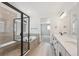Luxurious bathroom featuring double vanity, glass-enclosed shower and separate soaking tub at 1121 Joseph Pl, Erie, CO 80026