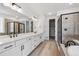 A modern bathroom with double vanity, soaking tub, and glass-enclosed shower at 1121 Joseph Pl, Erie, CO 80026