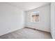 Bedroom with neutral carpet, white walls, and a large window providing natural light at 1121 Joseph Pl, Erie, CO 80026