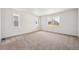 A bright and spacious bedroom with large windows and neutral carpeting at 1121 Joseph Pl, Erie, CO 80026