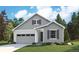 Craftsman style home with gray siding, white trim, and a two-car garage at 1121 Joseph Pl, Erie, CO 80026