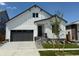 Charming two-story home with white siding, a gray garage door and a well-manicured lawn at 1121 Joseph Pl, Erie, CO 80026