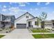 Charming two-story home featuring a modern exterior, well-kept lawn, and a two-car garage at 1121 Joseph Pl, Erie, CO 80026