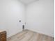 Utility room features wood-look floors and white walls with hookups for washer and dryer at 1121 Joseph Pl, Erie, CO 80026
