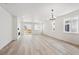 Bright living room with light wood floors, fireplace, and sliding glass doors to the backyard at 1121 Joseph Pl, Erie, CO 80026