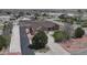 Expansive aerial view showcasing the property with a detached garage, green lawn, and surrounding neighborhood at 16350 Timber Cove St, Hudson, CO 80642
