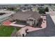 Sprawling home aerial view showcasing large patio, landscaped yard, and detached garage at 16350 Timber Cove St, Hudson, CO 80642
