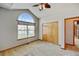 Bedroom with carpet, ceiling fan, and a large window at 16350 Timber Cove St, Hudson, CO 80642