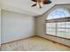 Comfortable bedroom with carpet, ceiling fan, and an arched window at 16350 Timber Cove St, Hudson, CO 80642