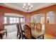 Open-concept dining area featuring hardwood floors and views of the living room at 16350 Timber Cove St, Hudson, CO 80642