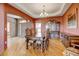 Elegant dining room featuring wood floors, a chandelier, and a classic china cabinet at 16350 Timber Cove St, Hudson, CO 80642